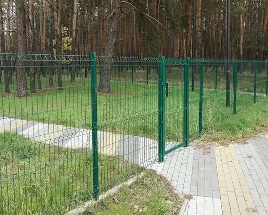 Durable mesh fence with 3D curves for added strength.